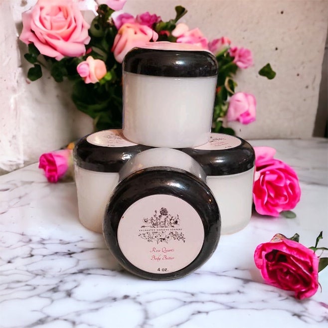 Jars of Rose Quartz Body Butter with floral decorations in the background.